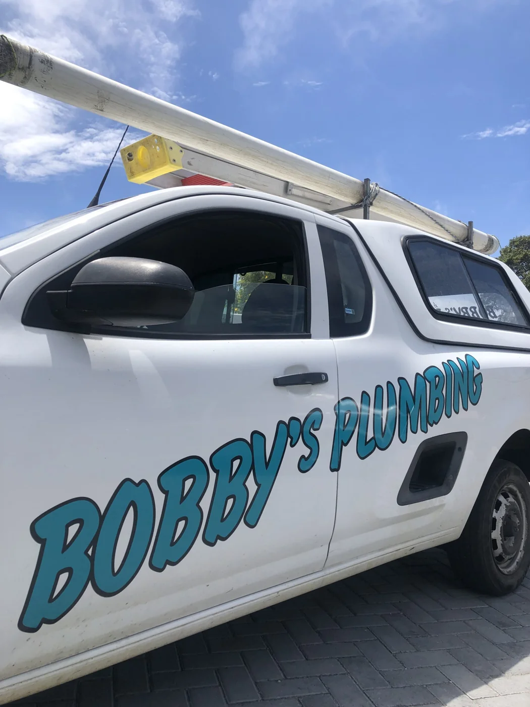 Bobby’s branded plumbing vehicle with ladders ready for a job