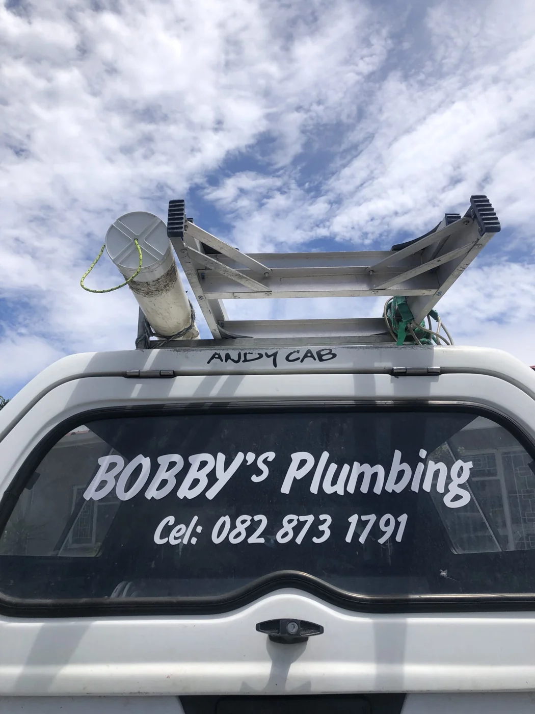 The rear of Bobby’s Plumbing vehicle with its business branding